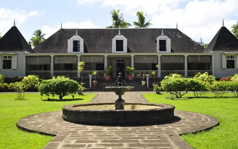 Maison coloniale mauricienne entourée d’un jardin tropical, témoin du patrimoine architectural de l’île Maurice.